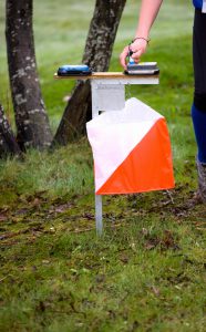 Orienteering runner taking an Control with RF-id based Control system. Focus on the Control